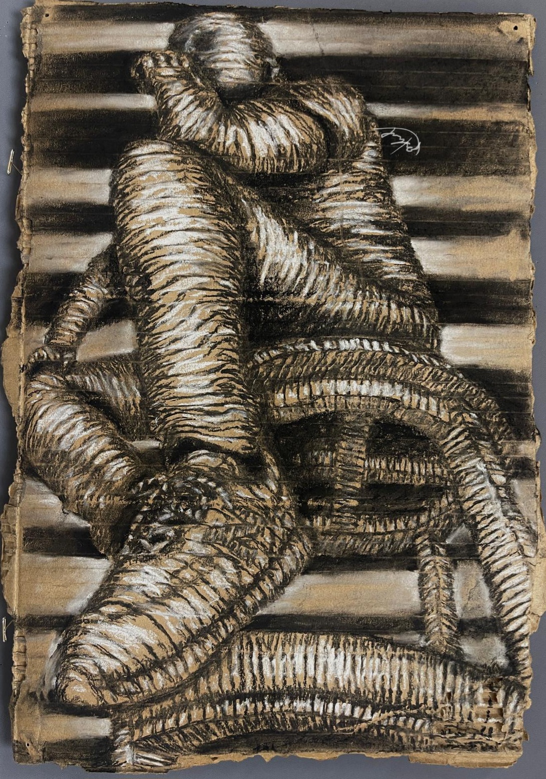 Black-and-white figure seated on a bench or stool.